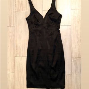 Fitted black plunging neck line dress.